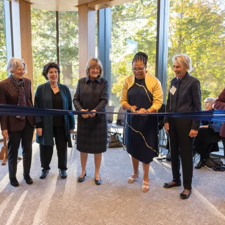 Kathleen McCartney and Sarah Willie-LeBreton with members of the Board of Trustees, cutting the ribbon at Kathleen McCartney Hall.