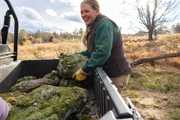Smith student Alex Blaszczyk ’27 moves rocks at MacLeish to make a home for snakes